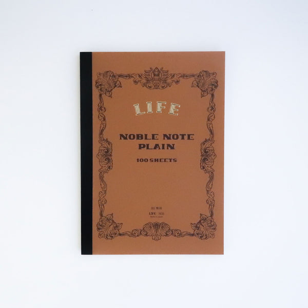 LIFE Noble Note B5 plain notebook with brown cover, ornate scroll border and black taped spine.