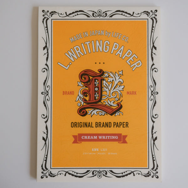 LIFE L. Writing Paper letter pad cover with orange panel, ornate scrollwork border and Cream Writing banner.