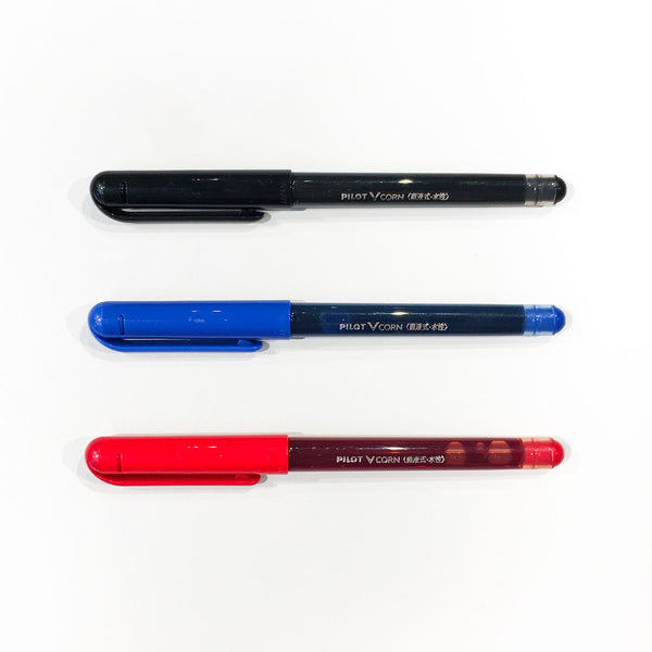 Three capped Pilot Vcorn rollerball pens in Black, Blue and Red, arranged in a row.
