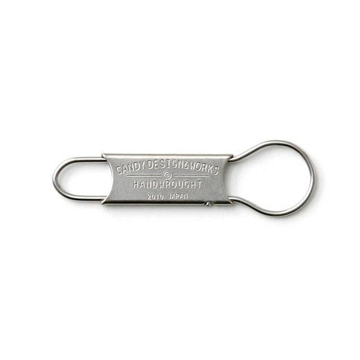 Stainless steel key ring with stamped "Candy Design & Works Handwrought" plate and two wire loops.
