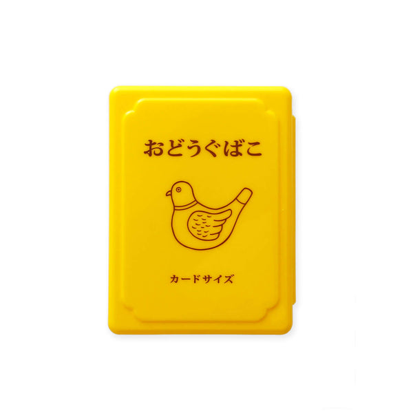 Yellow plastic mini tool box with Japanese text and a line-drawn bird printed on the lid.