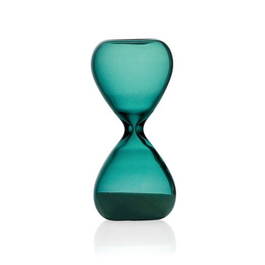 Hightide small glass hourglass in Turquoise Blue, sand collected in the lower bulb, on white background.