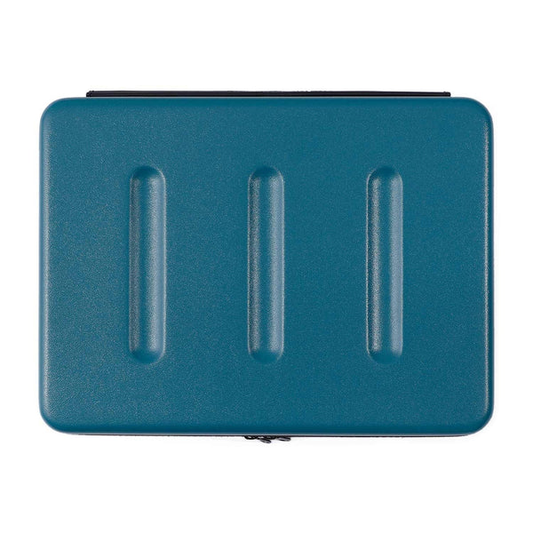 Nähe hard shell laptop case in Blue, closed and viewed from above with three ridged grooves and zipper.