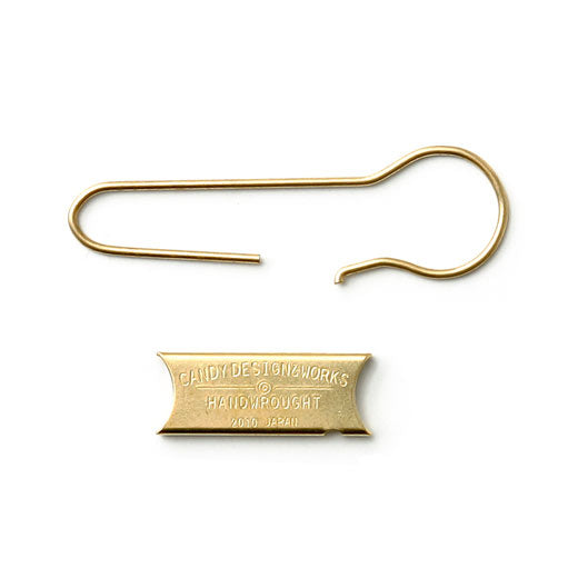 Brass hook-style key ring with a stamped Candy Design & Works metal tag below it.