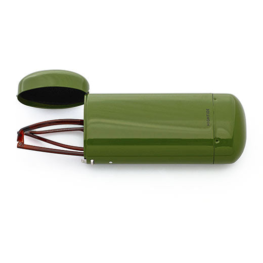 Khaki stainless steel glasses case by Hightide lying open with dark lining and wire-frame glasses beside it.